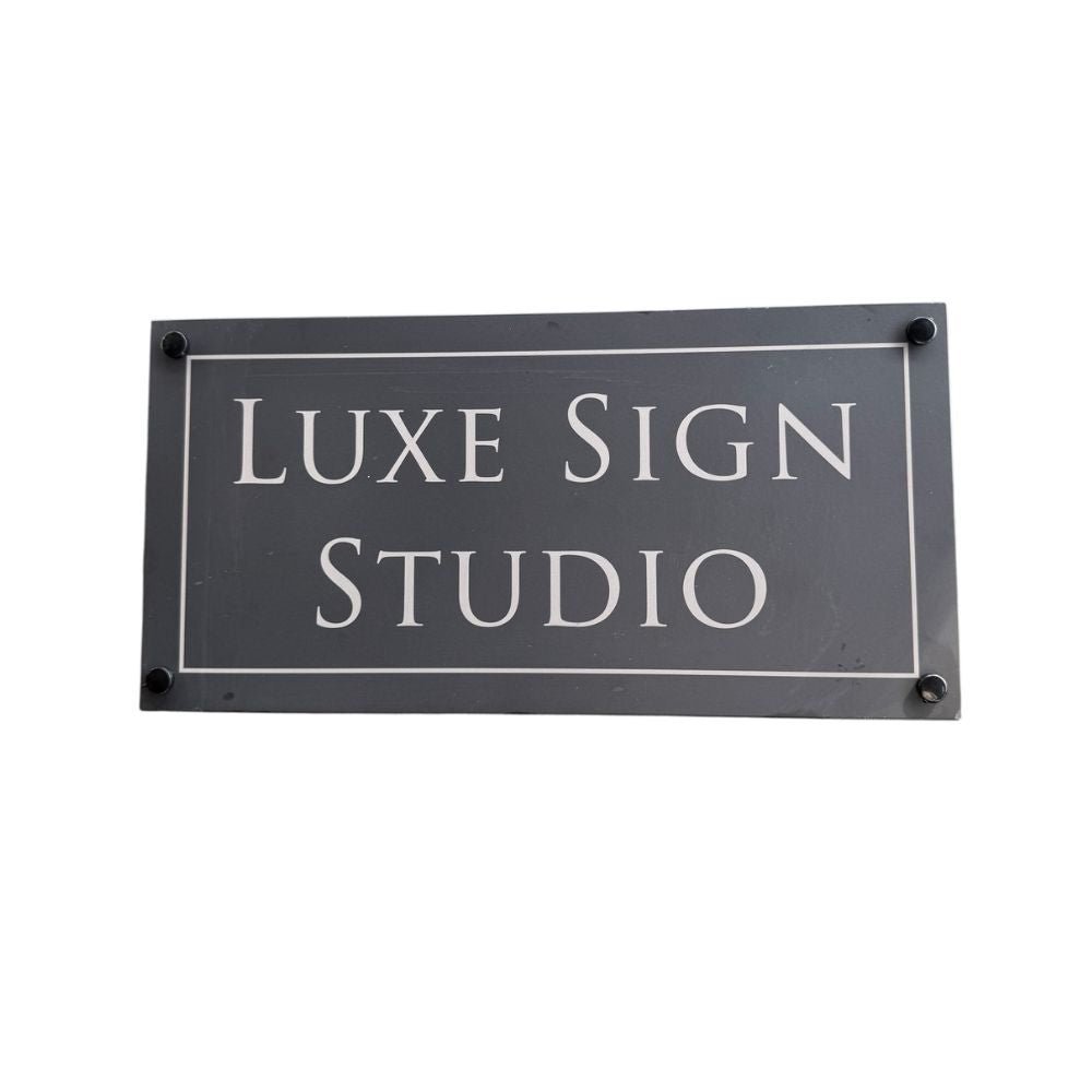 Rectangular sign with 'LUXE SIGN STUDIO' text on a white background