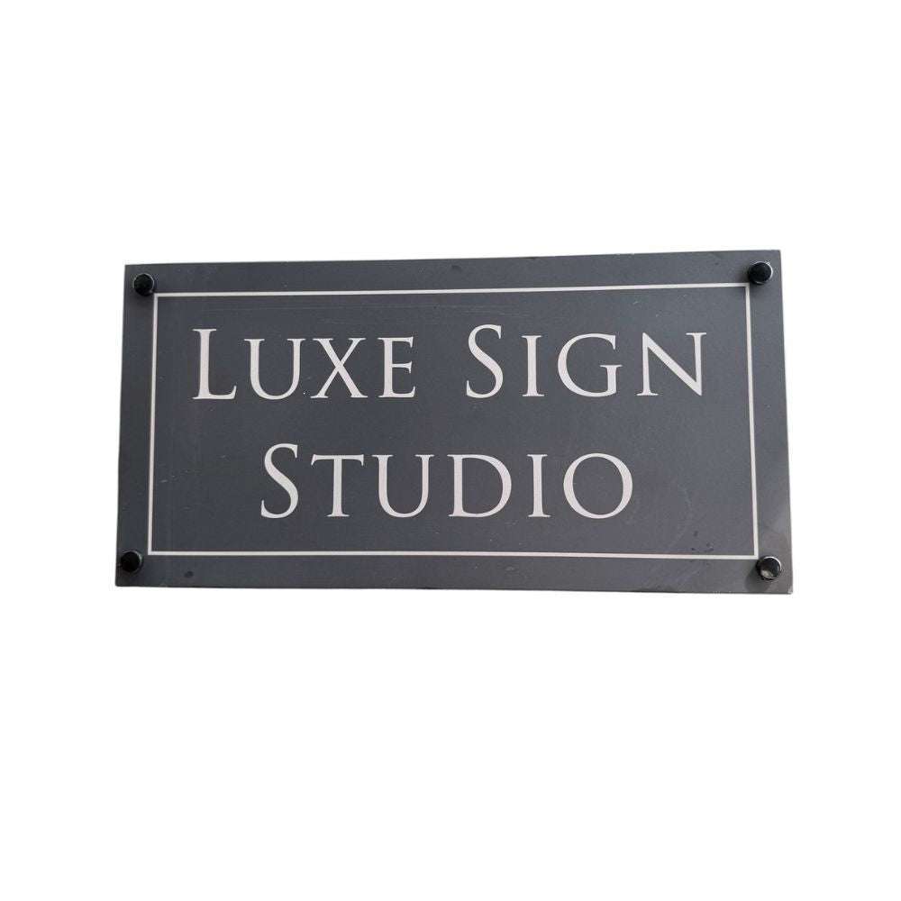 Rectangular sign with 'LUXE SIGN STUDIO' text on a white background
