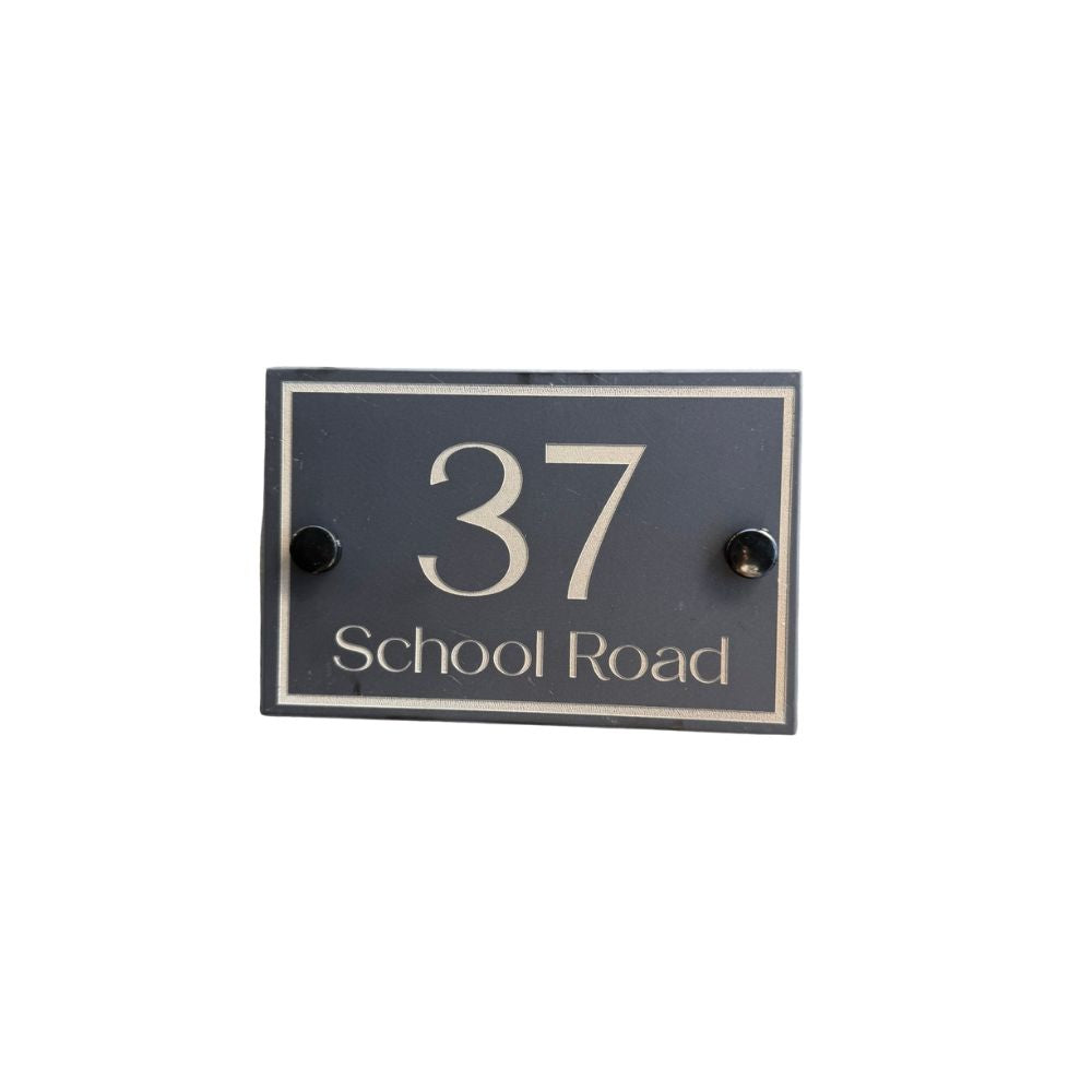 Black house number sign with '37 School Road' on a white background