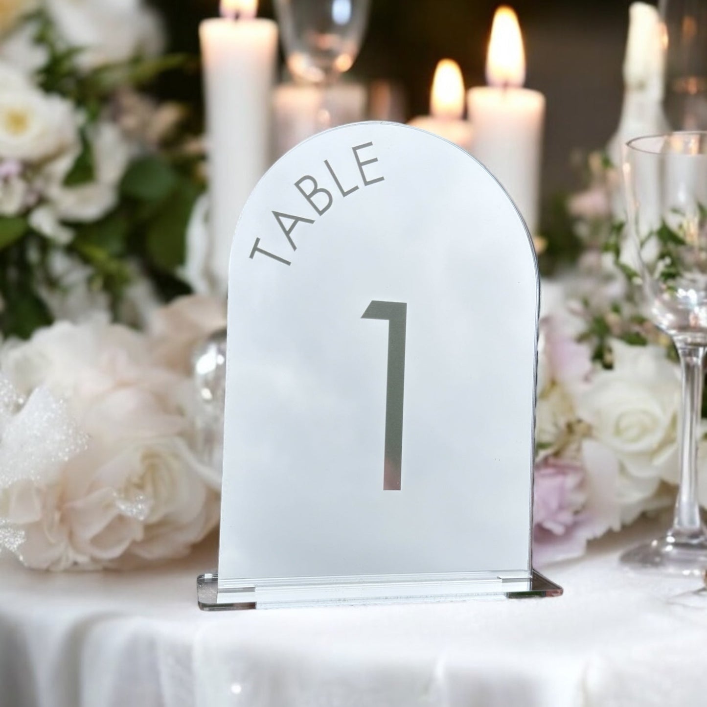 Close-up of two font options for mirror arch table numbers in silver