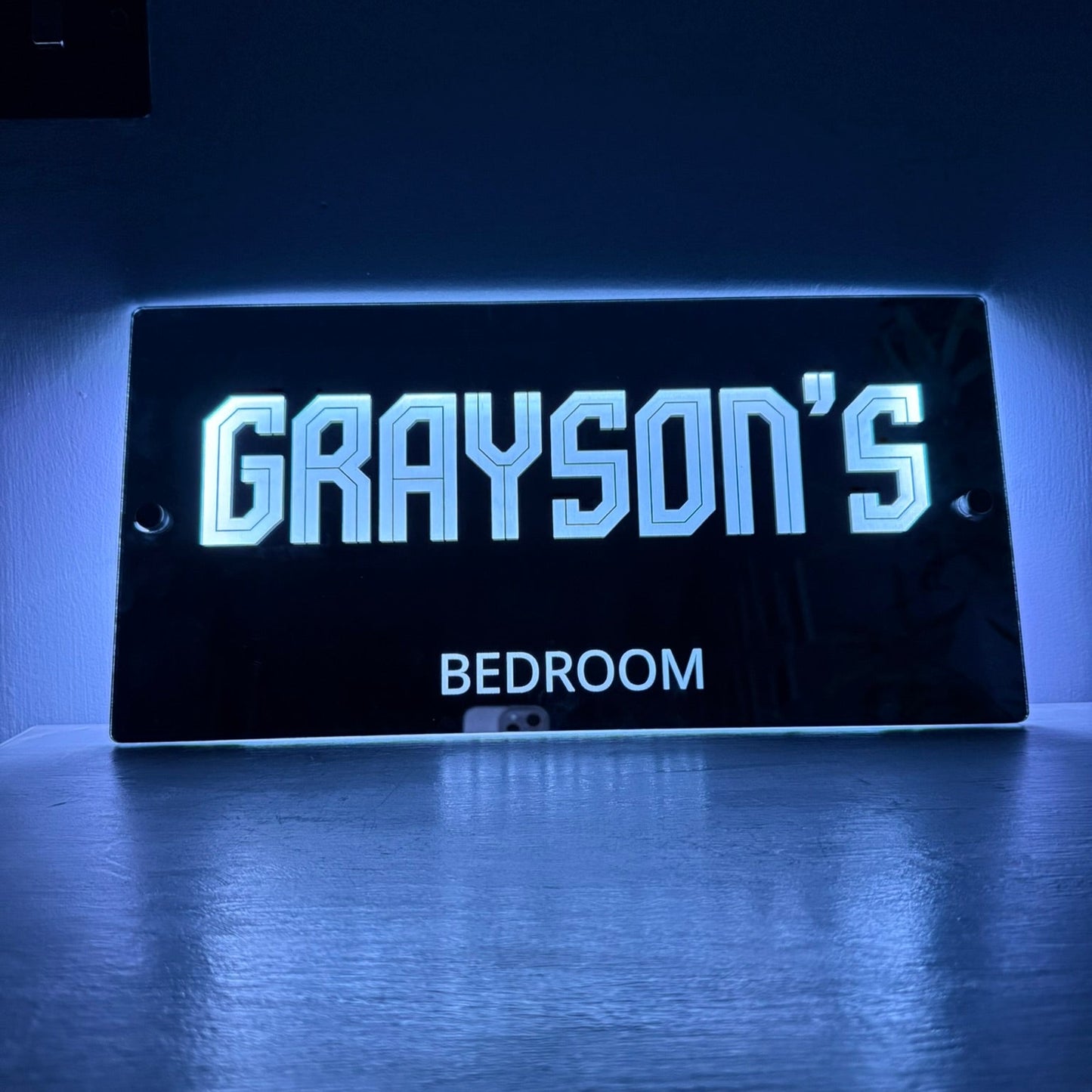 Detailed close-up of the mirror finish with personalised name and glowing LED edge