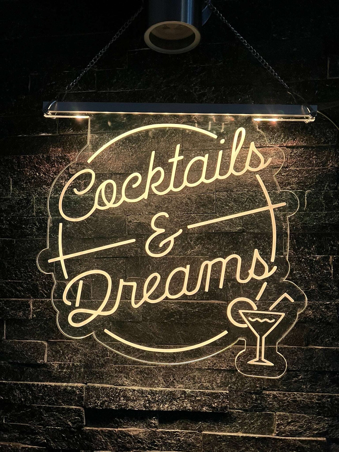 Illuminated “Cocktails & Dreams” sign with LED effects