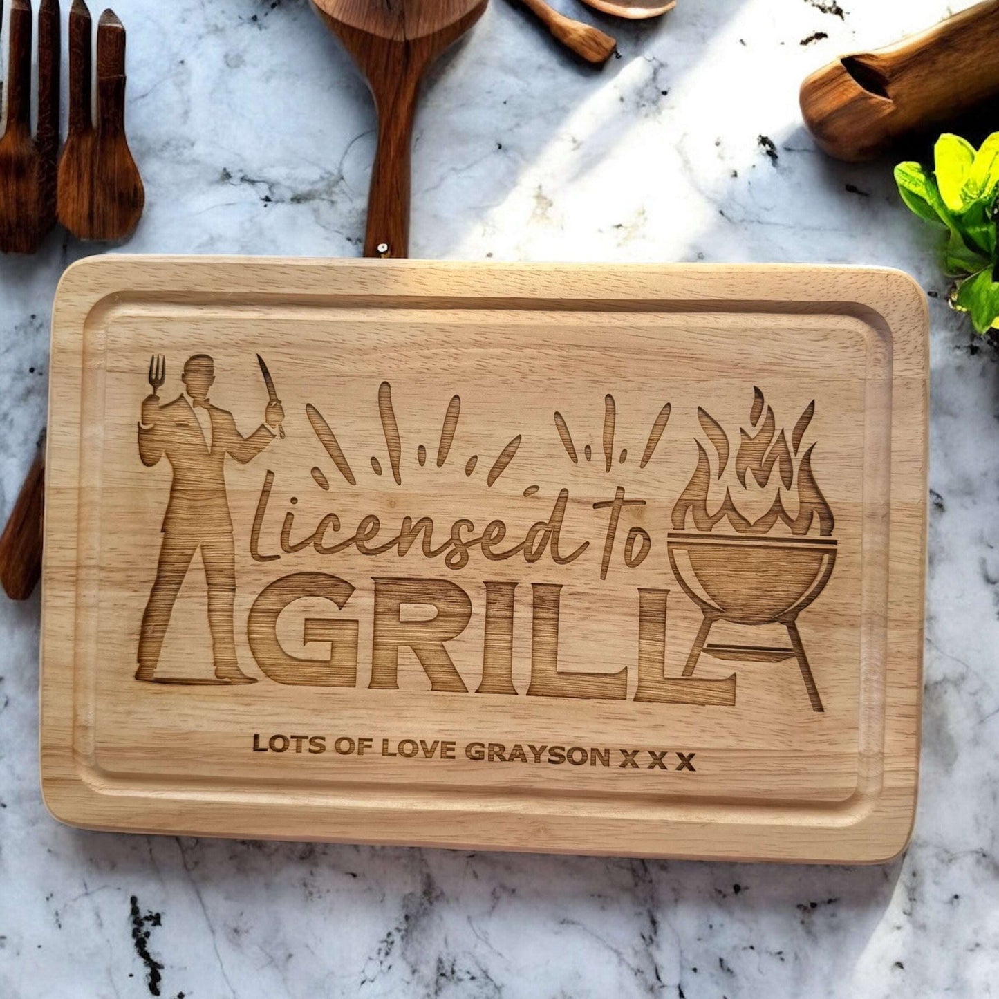 Wooden BBQ tray engraved with “Licensed To Grill” and kids’ names