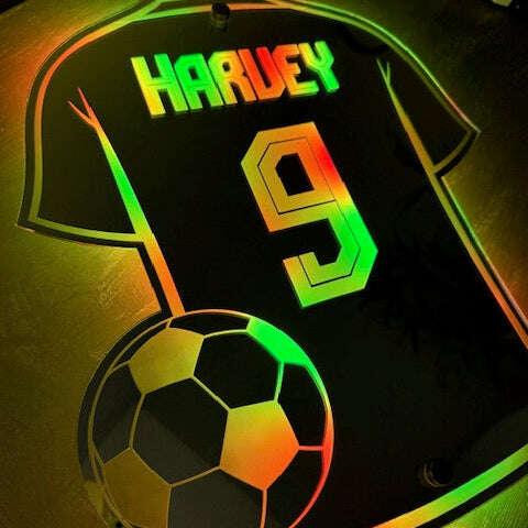 Personalised mirror sign shaped like a football shirt.