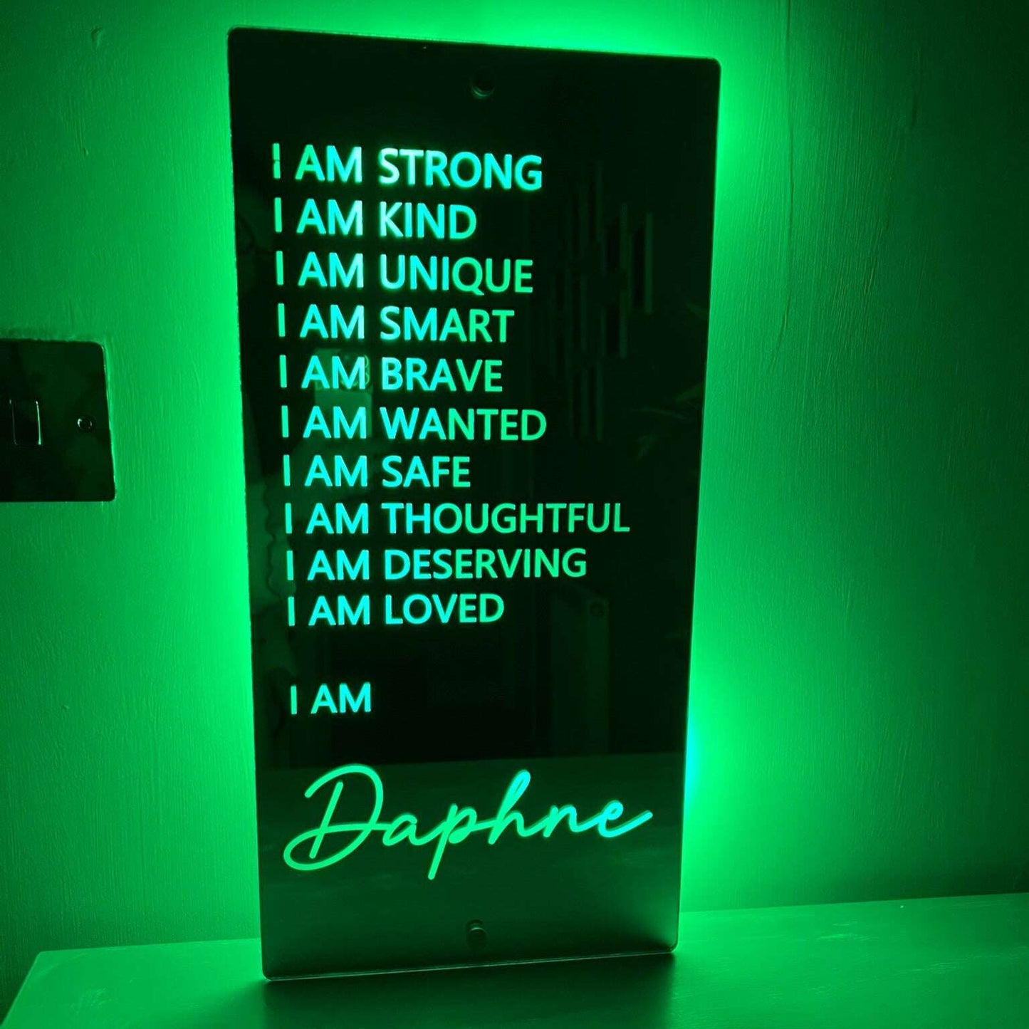 Glowing LED mirror sign with uplifting messages