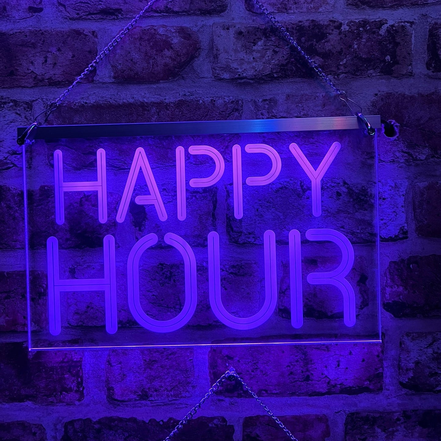 Happy Hour LED sign lighting up a home bar area with vibrant hues.