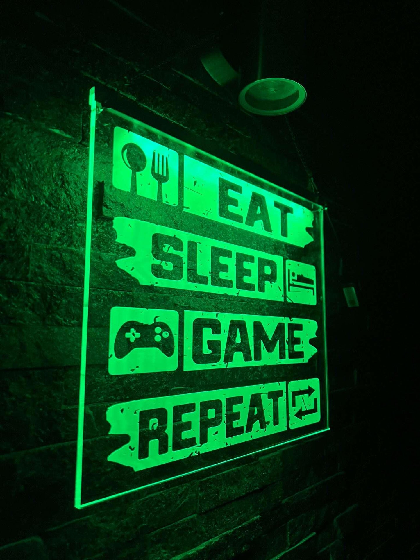 Vibrant LED bar illuminates “Eat Sleep Game Repeat” gaming sign