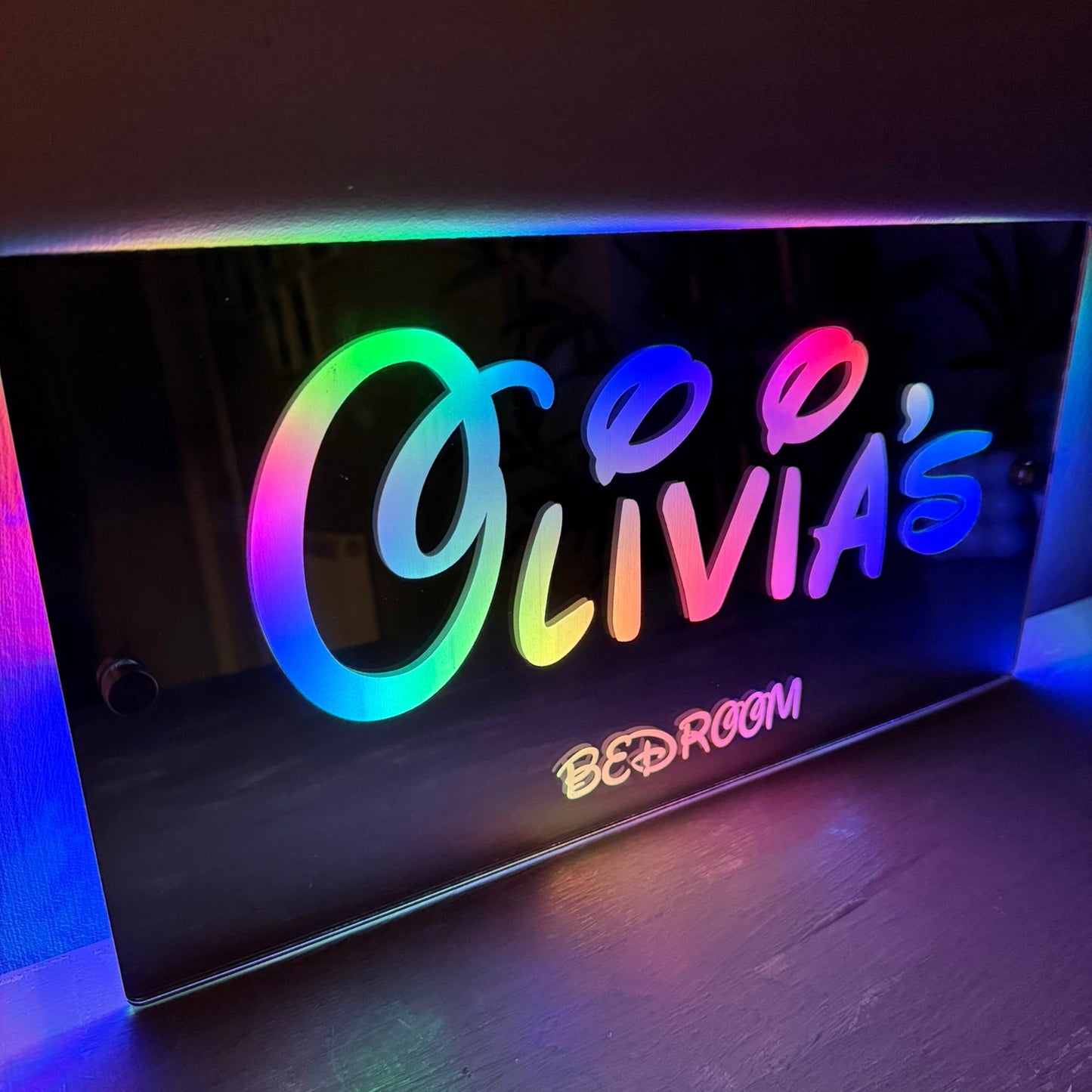 Personalised LED mirror sign packaged as a birthday gift for kids, featuring colourful lighting and custom name.
