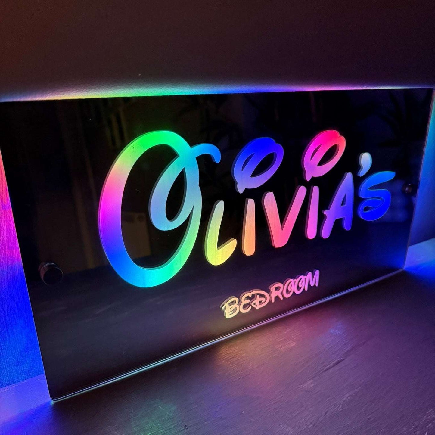 Personalised LED mirror sign packaged as a birthday gift for kids, featuring colourful lighting and custom name.