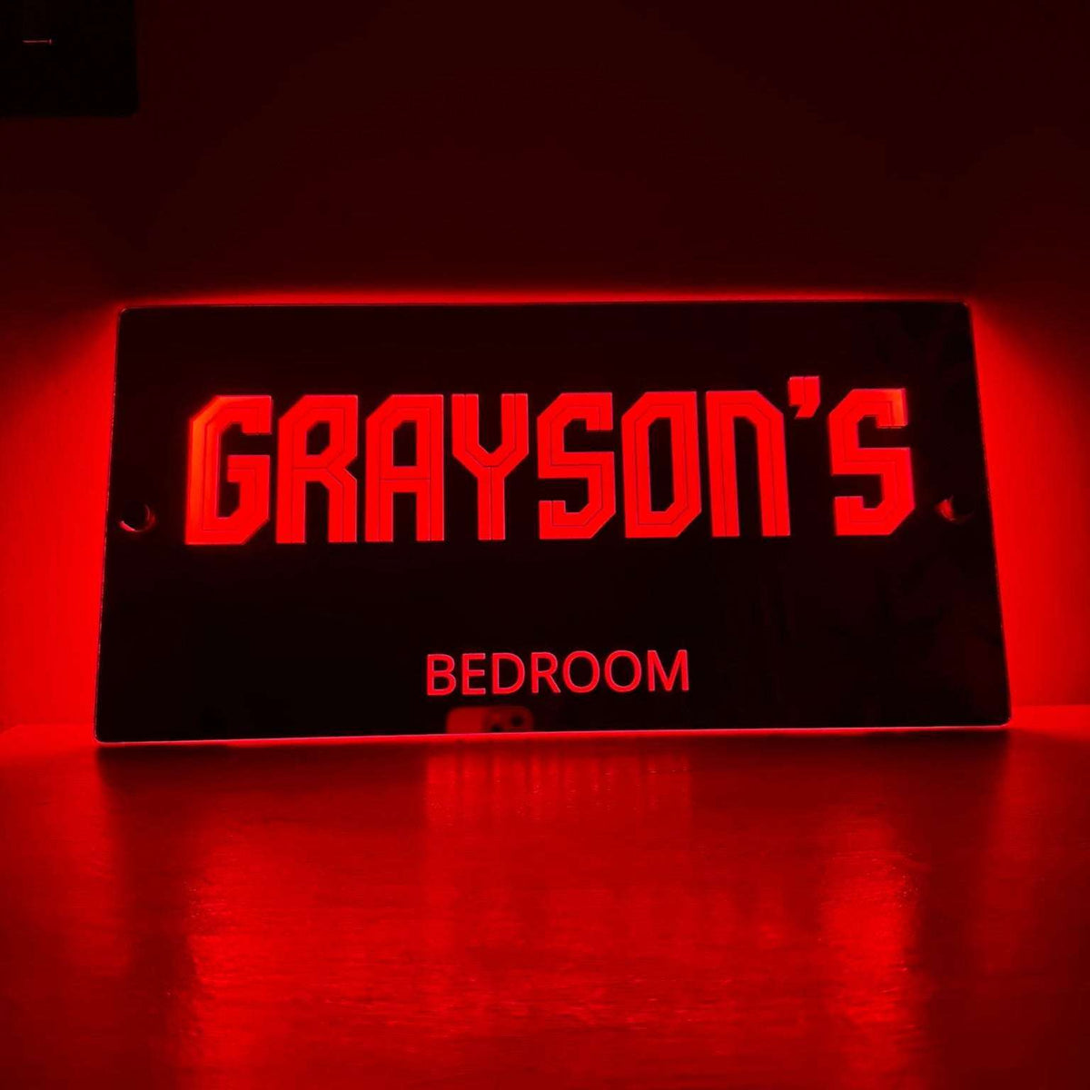 Softly lit LED mirror sign in a child’s bedroom at night, creating a cosy and magical atmosphere