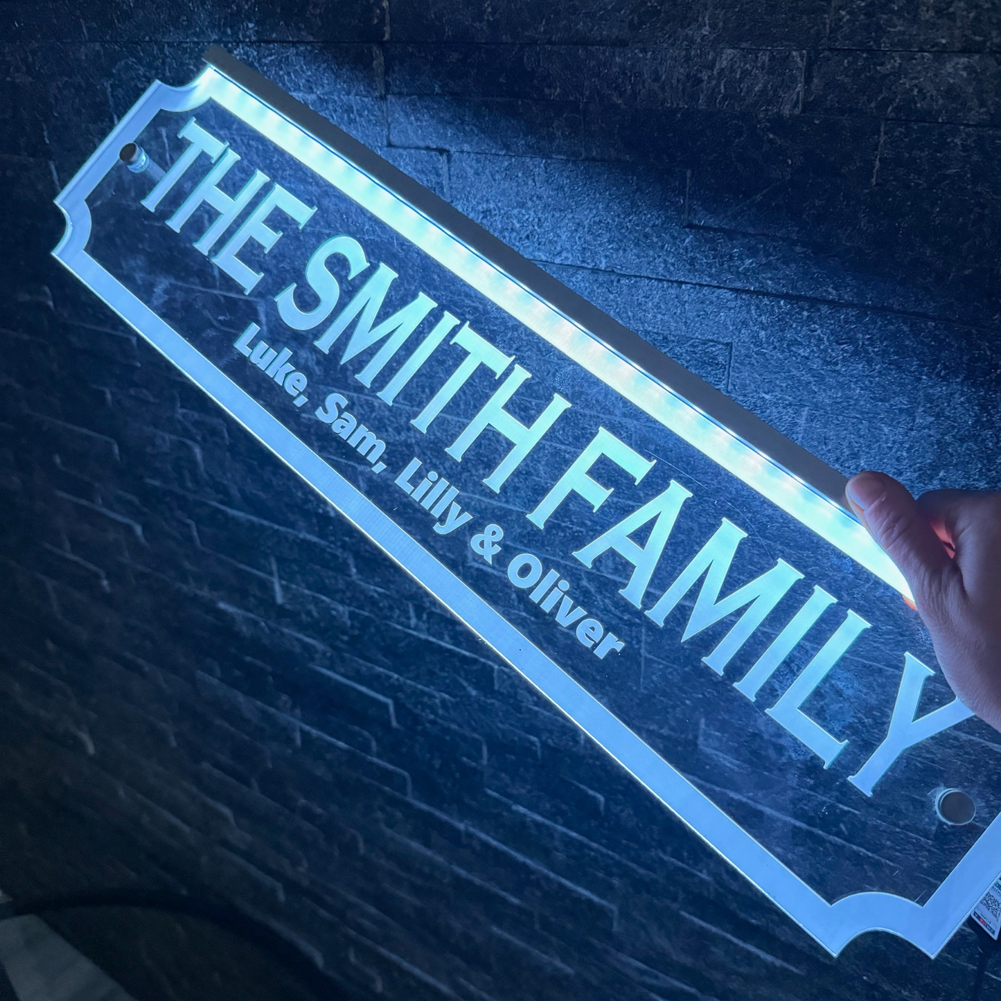 Personalised LED family street sign mounted on a home bar wall