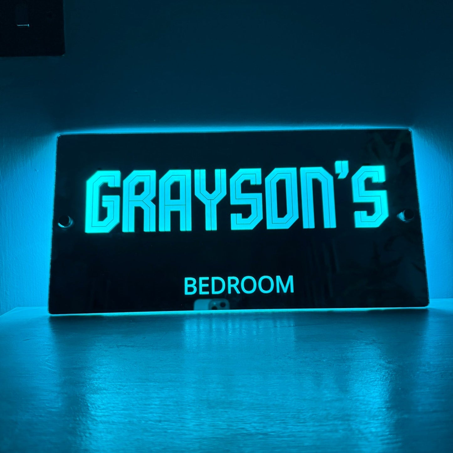 Personalised LED mirror sign wrapped as a gift, ideal for birthdays or Christmas presents