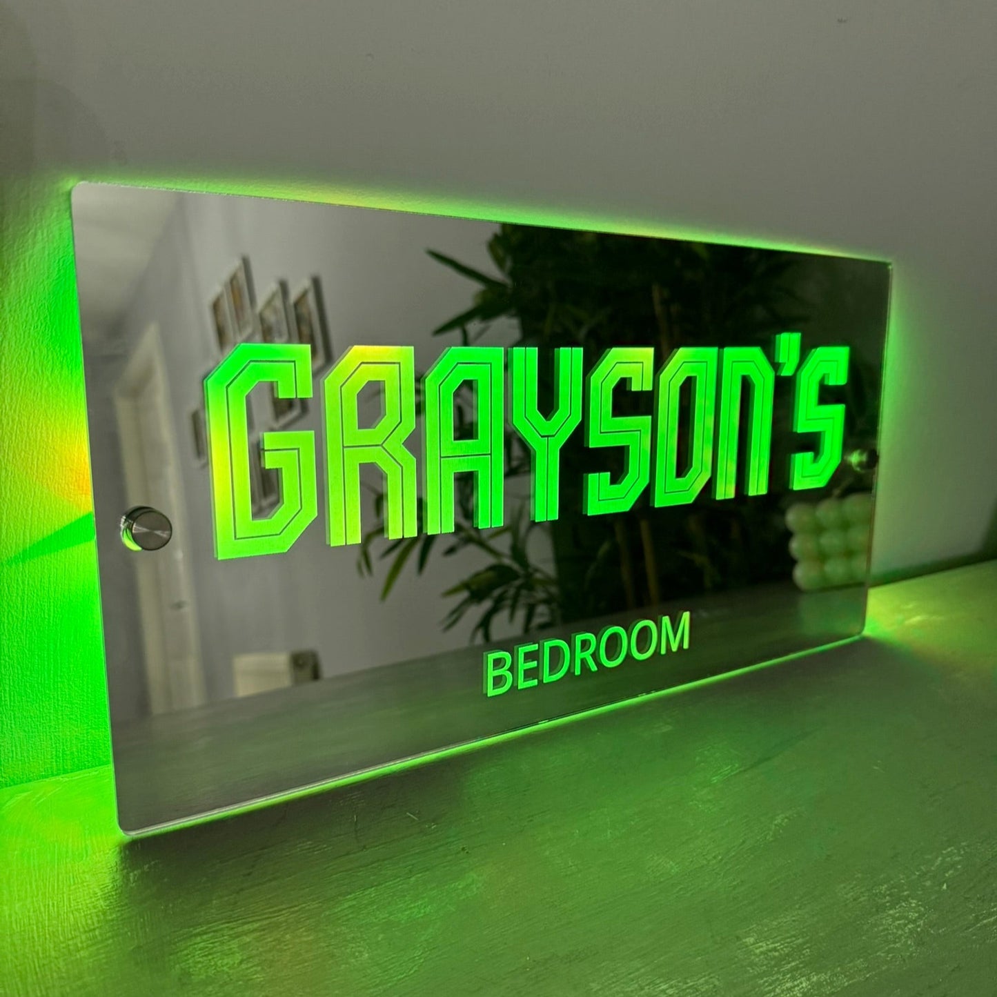 LED mirror sign with included remote control and USB power cable for easy operation.