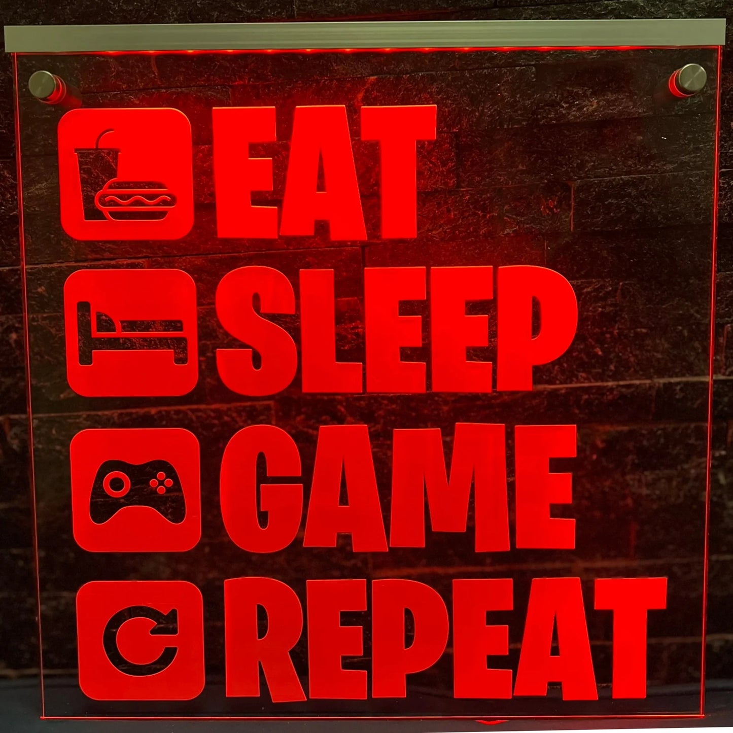 Gaming room LED sign with iconic "Eat Sleep Game Repeat" phrase