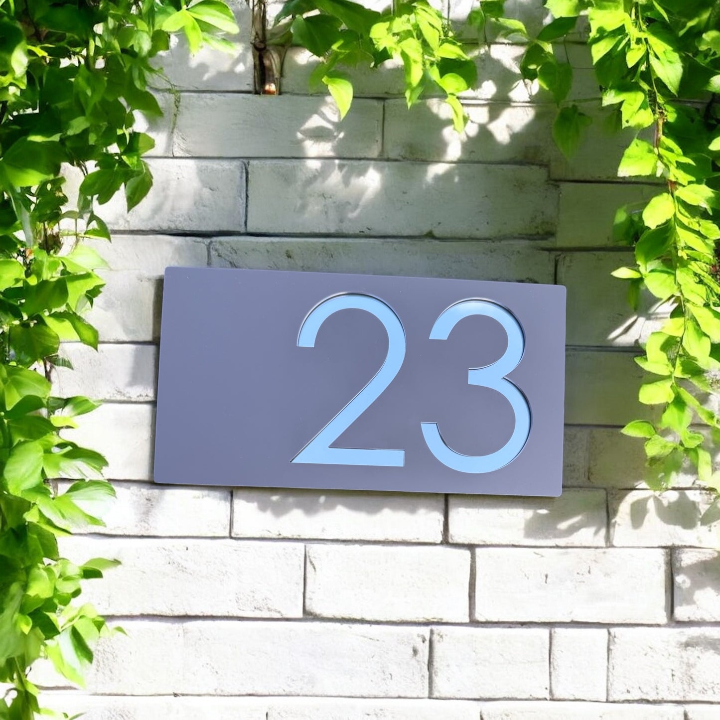 Close-up of mirror acrylic reflecting sunlight on house sign