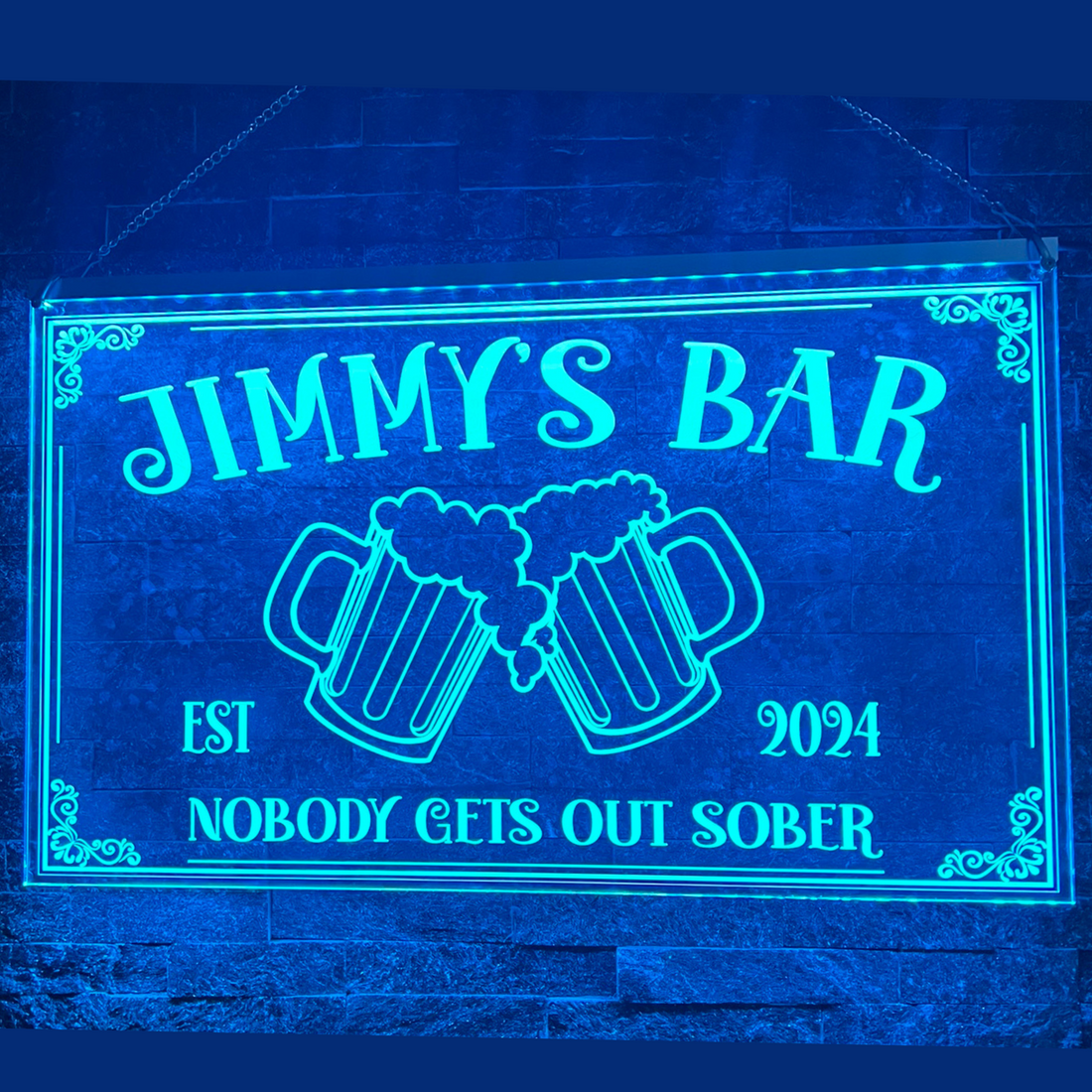 Personalised LED home bar sign with custom name, glowing in vibrant colours, mounted on wall above a home bar setup
