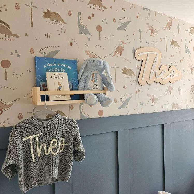 Personalised nursery sign with child’s name and LED night light glowing softly in a cosy baby room