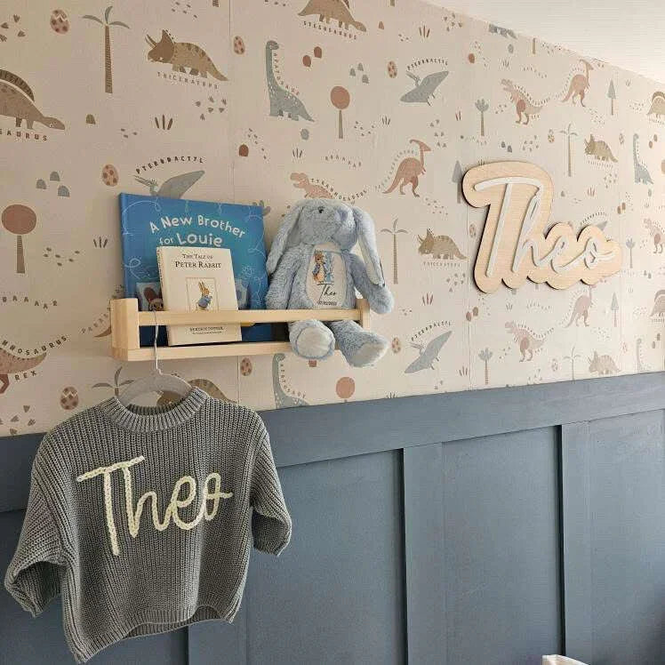 Personalised nursery sign with child’s name and LED night light glowing softly in a cosy baby room