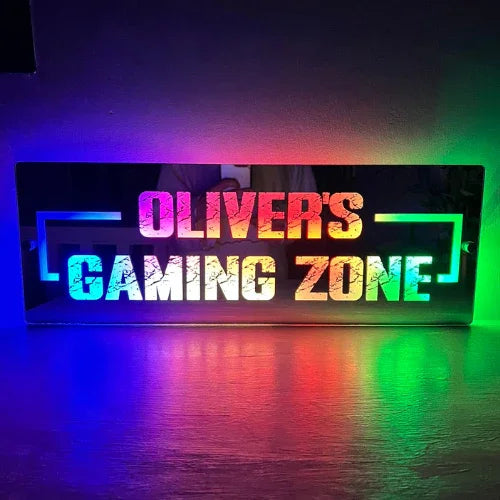 Personalised LED gaming sign displaying a gamer username, glowing in a dark streaming room setup