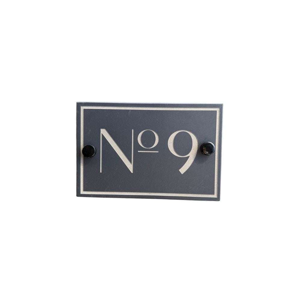 Navy blue rectangular sign with white text 'No 9' on a white background