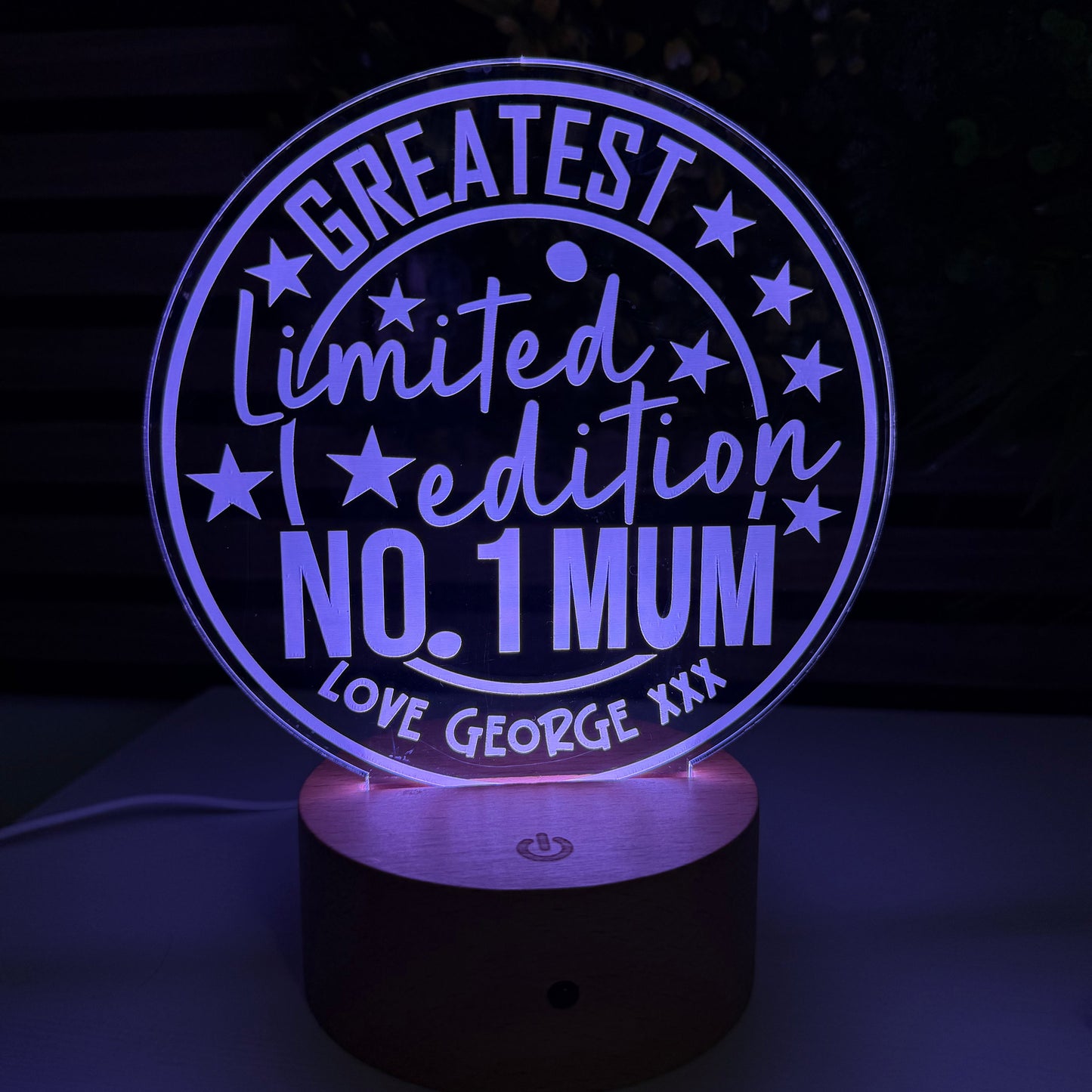 Decorative light with 'Greatest Limited Edition No. 1 Mum' text on a dark background