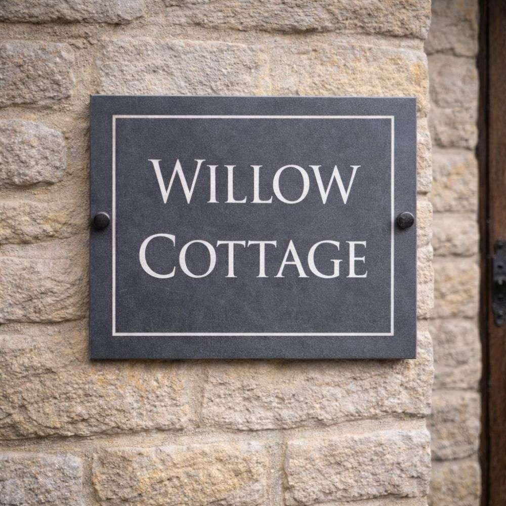 Slate house sign with 'Willow Cottage' on a stone wall