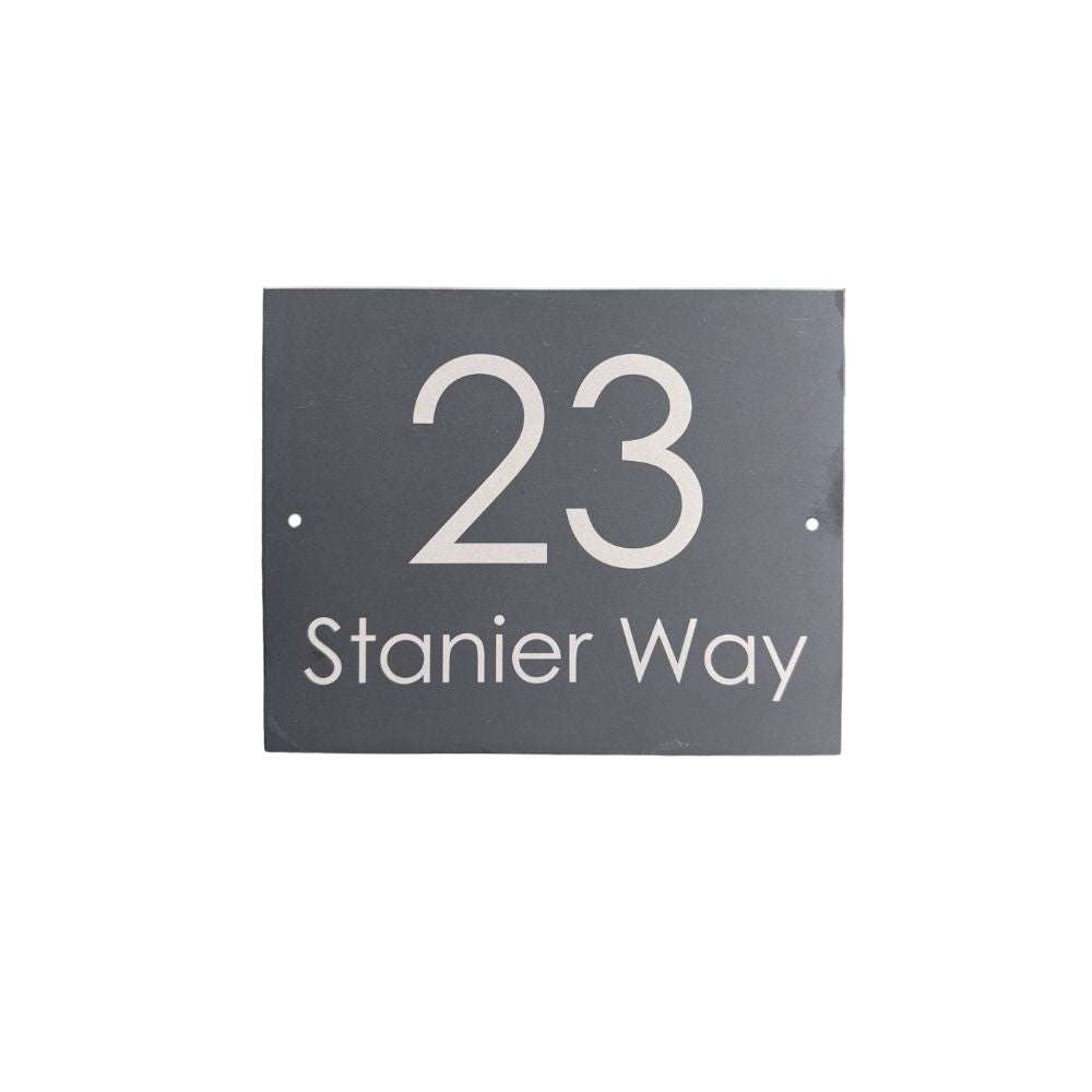 House number sign with '23 Stanier Way' on a black background