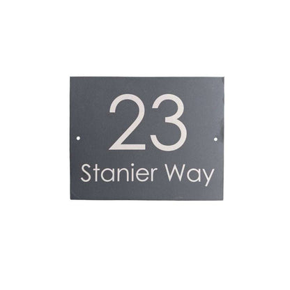 House number sign with '23 Stanier Way' on a black background