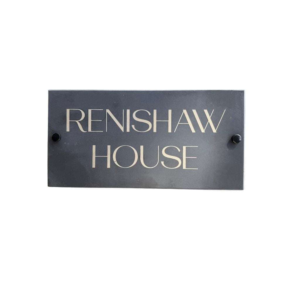 Rectangular metal sign with 'RENISHAW HOUSE' text on a white background
