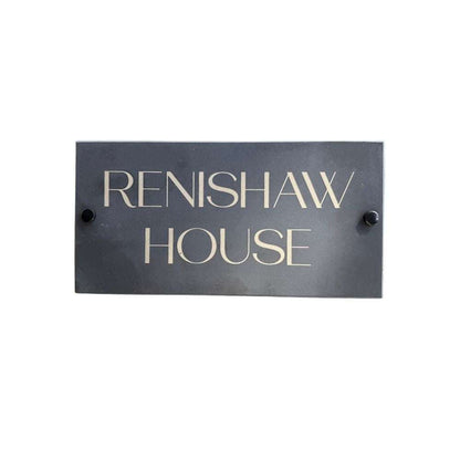 Rectangular metal sign with 'RENISHAW HOUSE' text on a white background