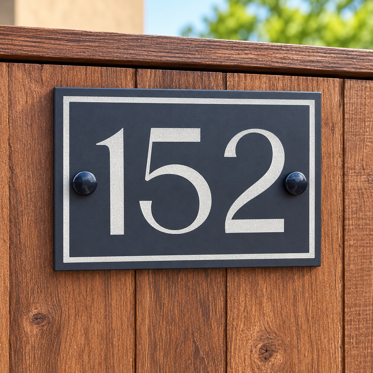 House number 152 sign fixed to a wooden fence