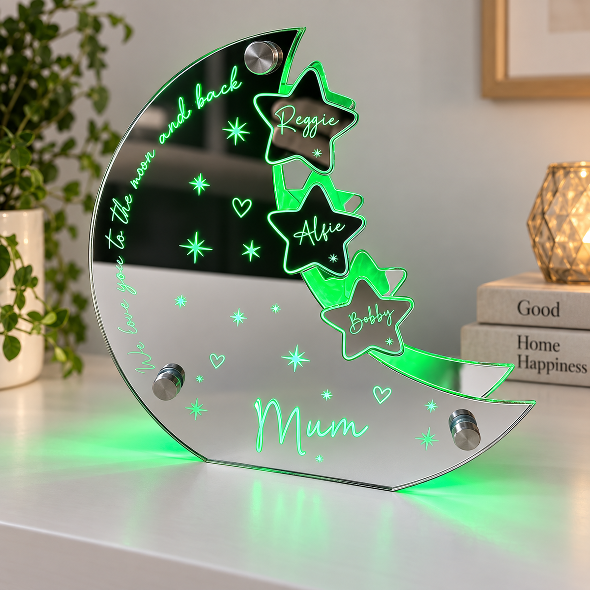 Mirror acrylic moon and stars LED sign with family names, lit green