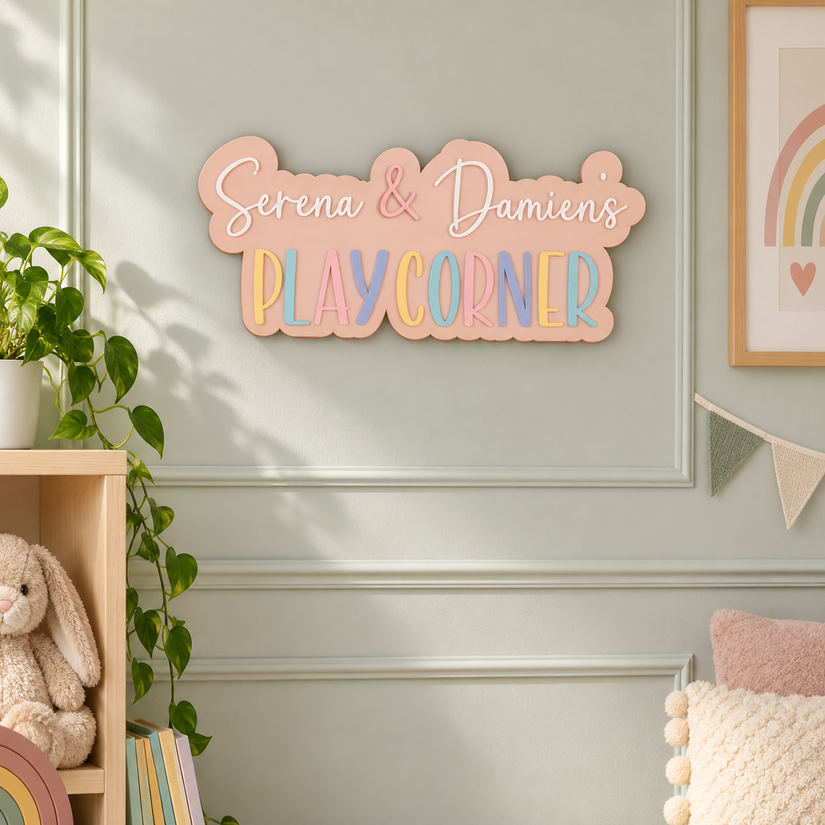 Pastel acrylic Serena & Damien's Play Corner sign on a playroom wall