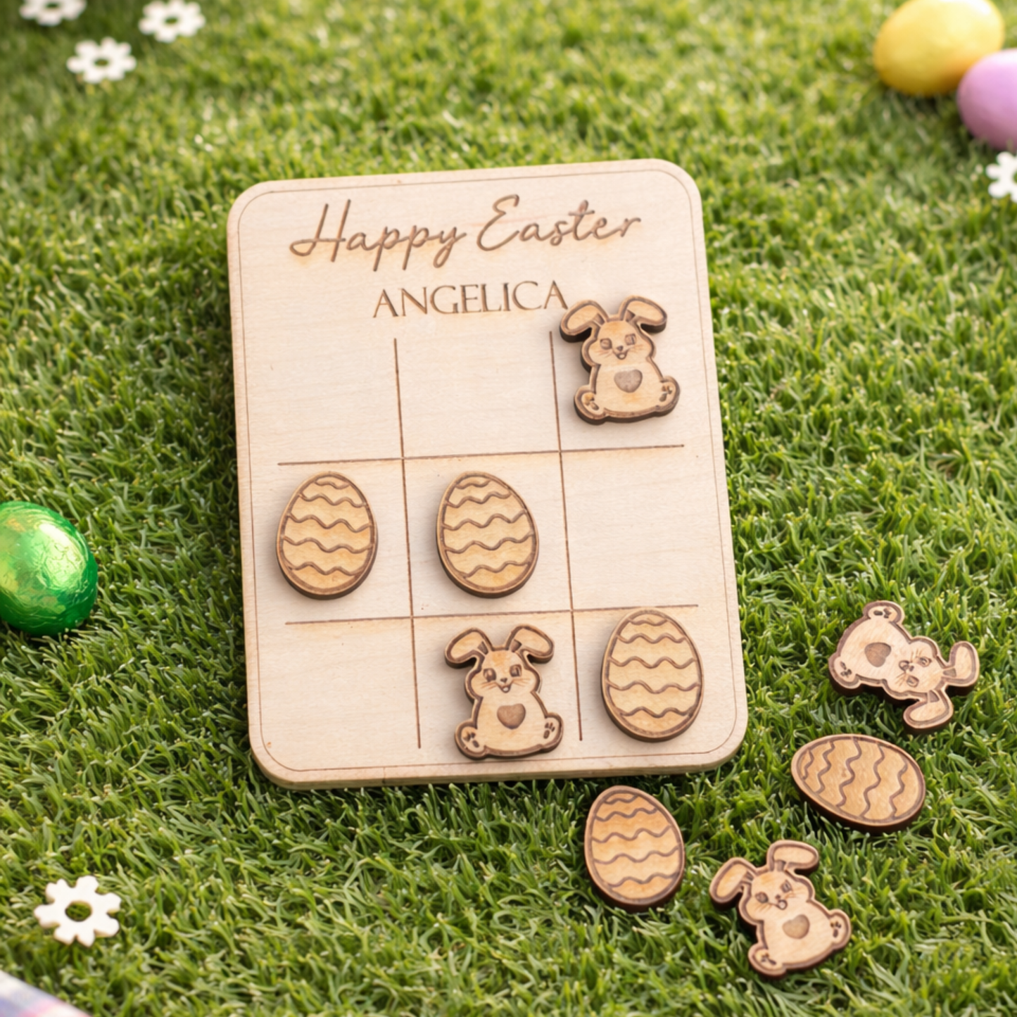 Wooden Easter card with cut-out designs on a grass background