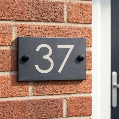 House number '37' on a brick wall