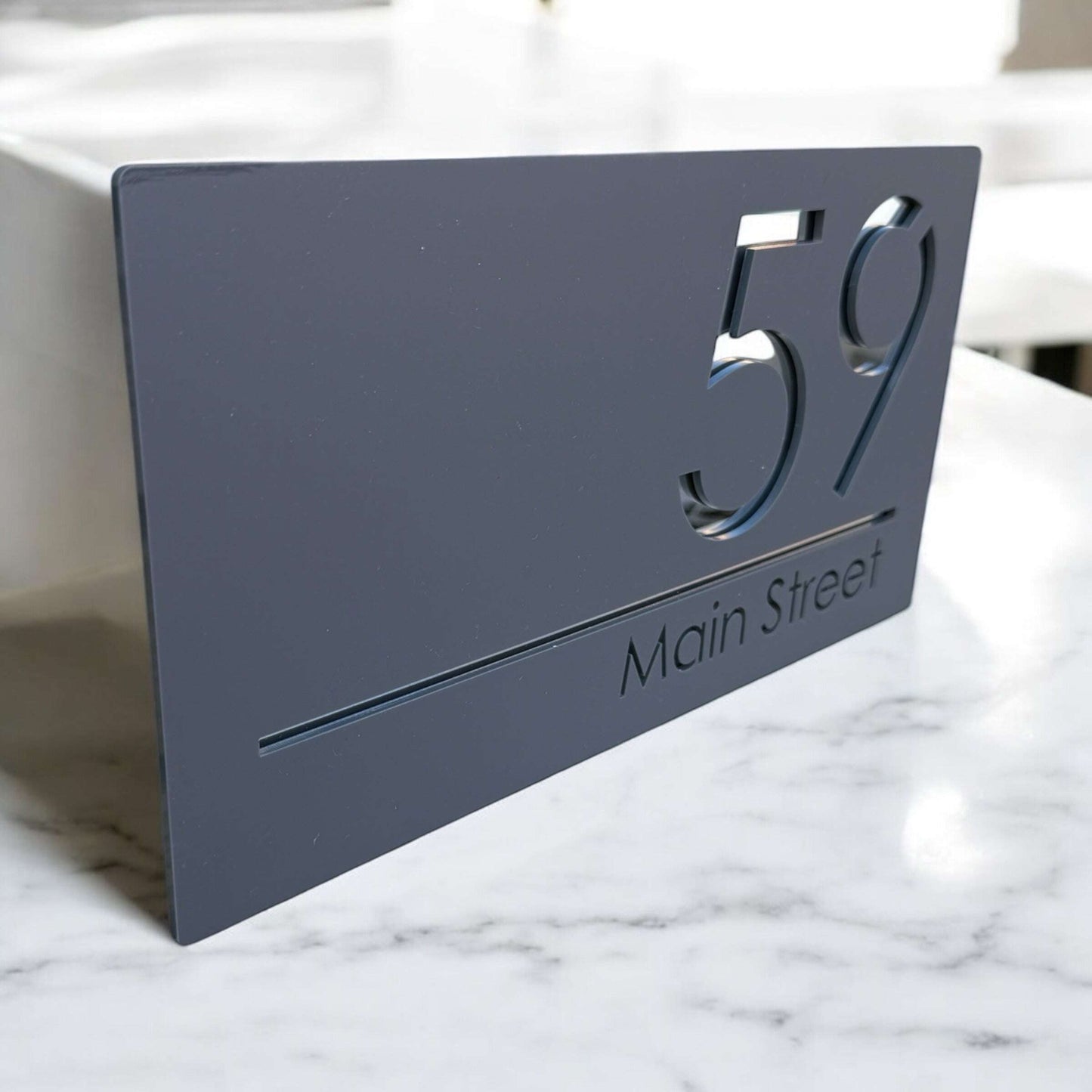 Personalised acrylic house sign featuring street name and number in floating style