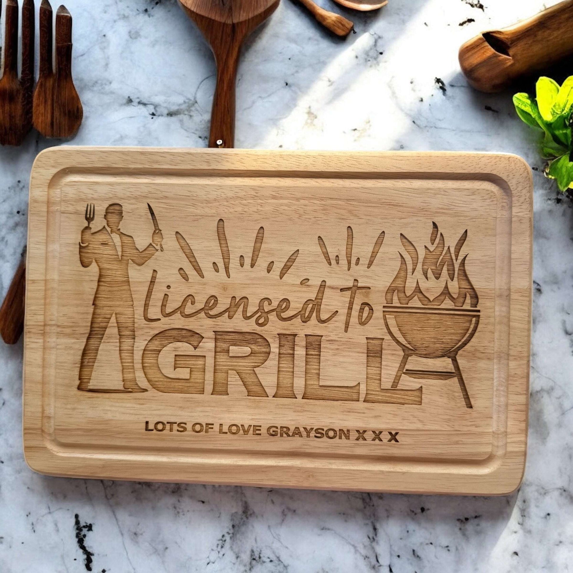 Wooden BBQ tray engraved with “Licensed To Grill” and kids’ names