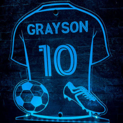 Wall-mounted personalised LED football shirt sign glowing in multiple colours