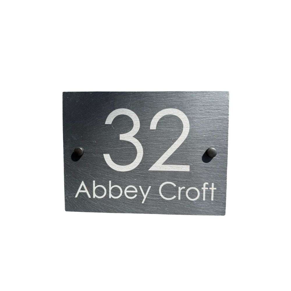 Slate house number sign with '32 Abbey Croft' on a white background