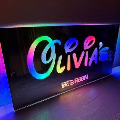 Personalised LED mirror sign packaged as a birthday gift for kids, featuring colourful lighting and custom name.