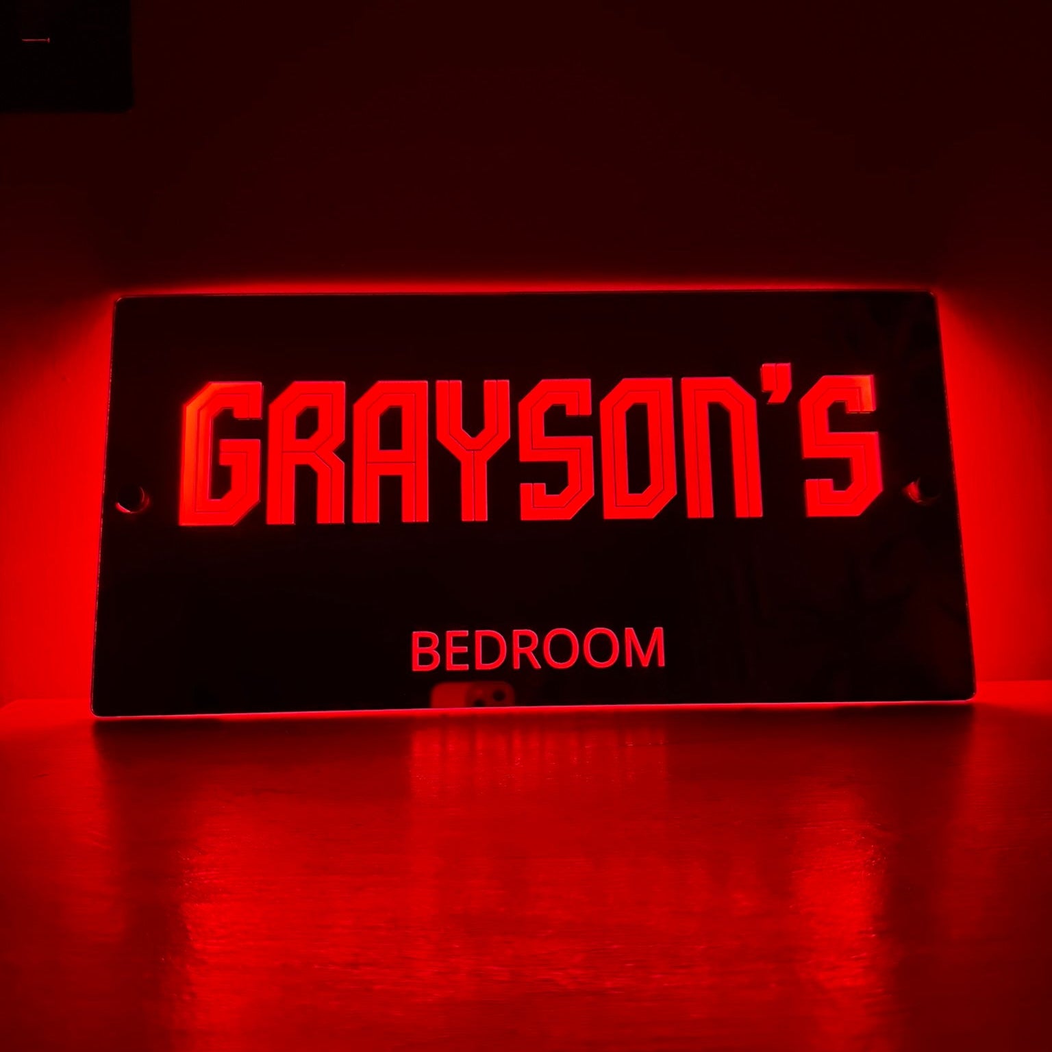 Softly lit LED mirror sign in a child’s bedroom at night, creating a cosy and magical atmosphere
