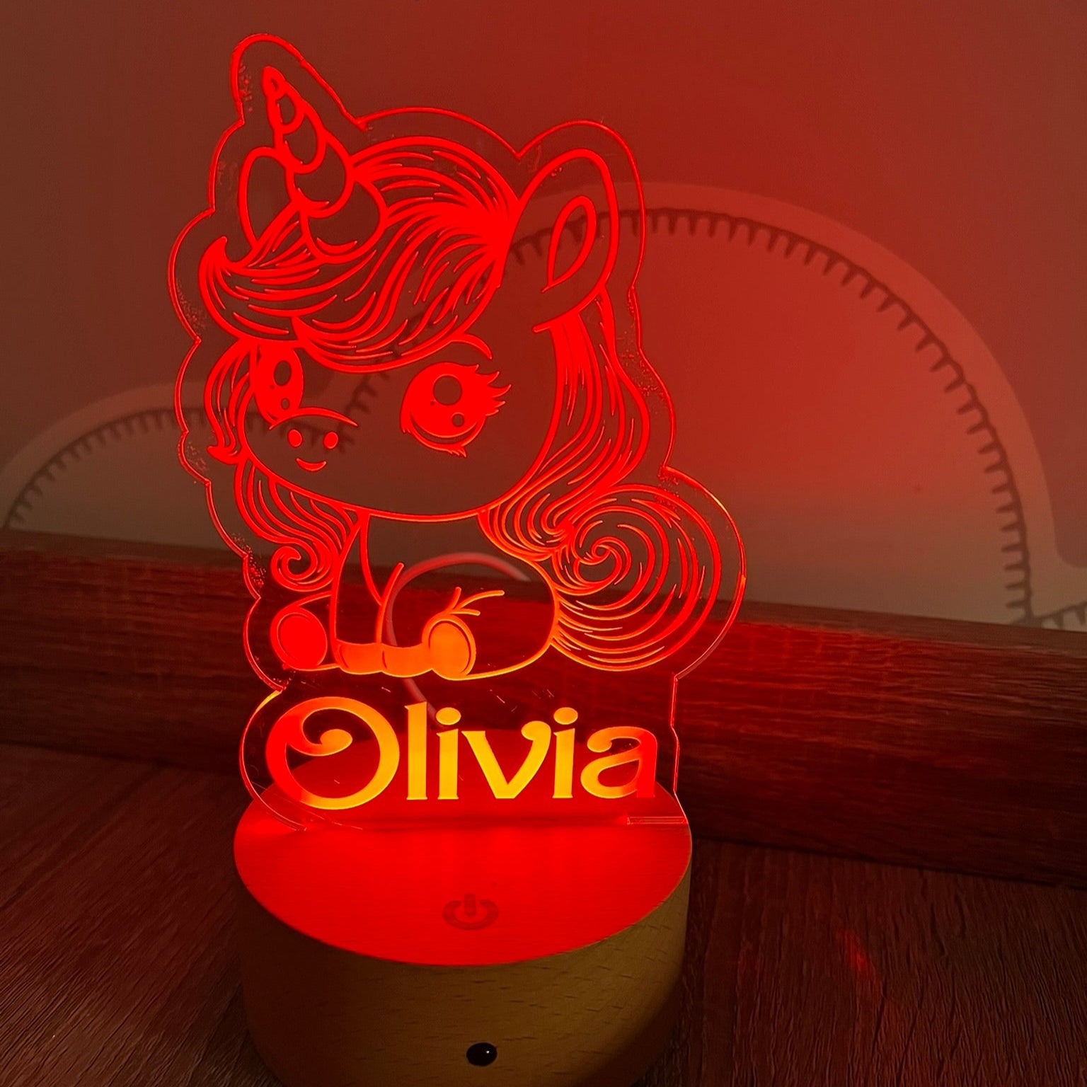Custom name unicorn lamp glowing softly in a dark room