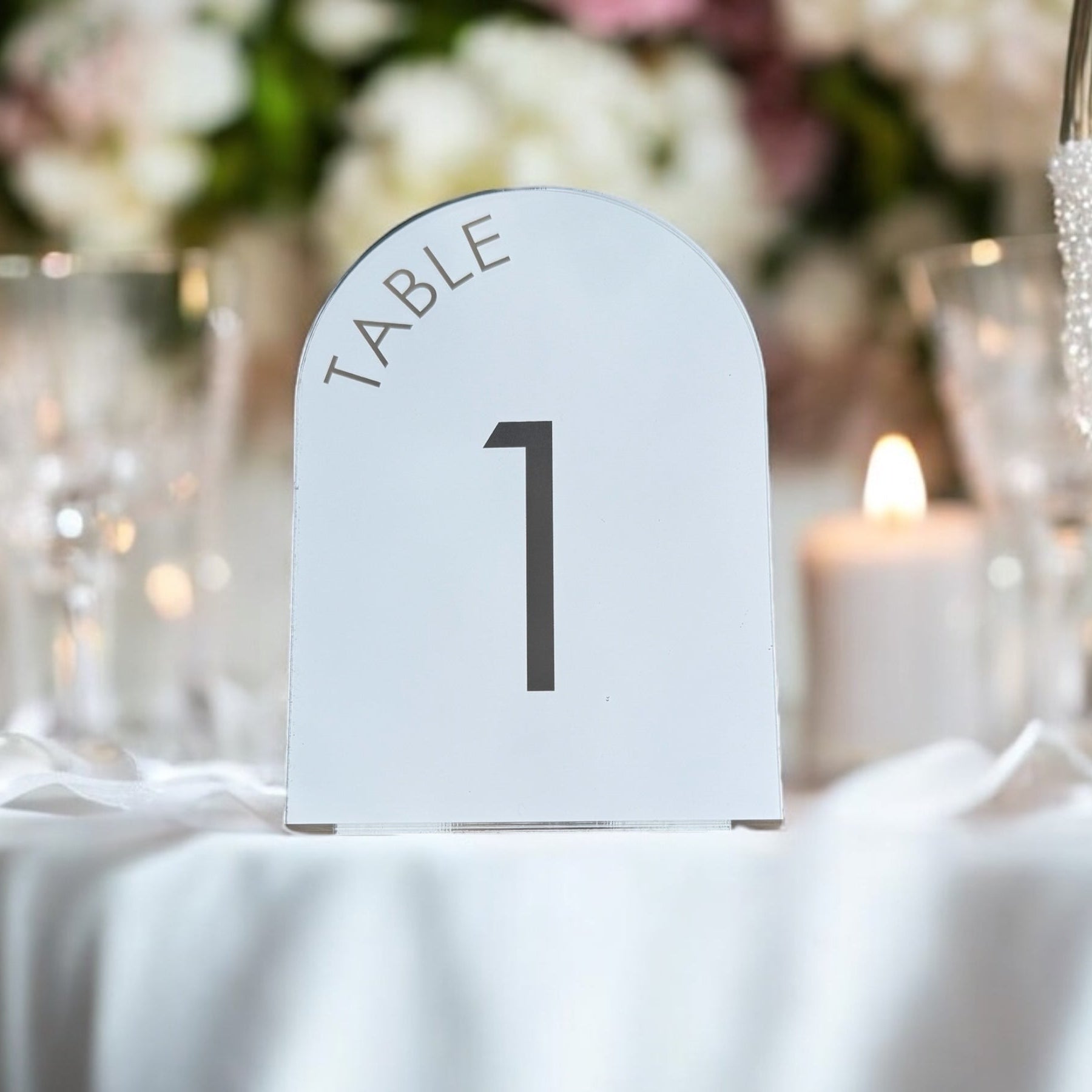 Set of mirror arch table numbers styled on wedding reception tables