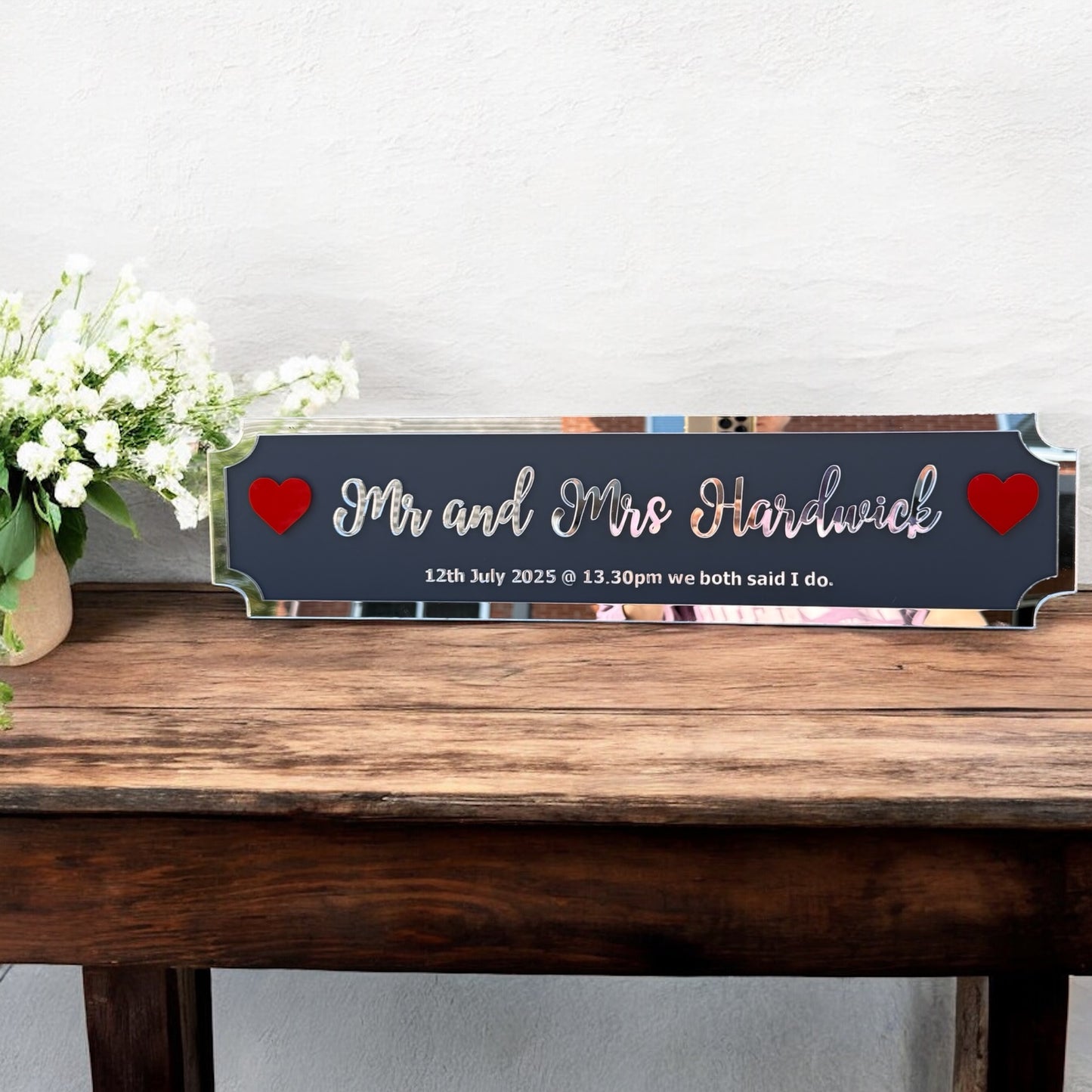 Personalised Mr & Mrs plaque mounted on living room wall with hearts on sides